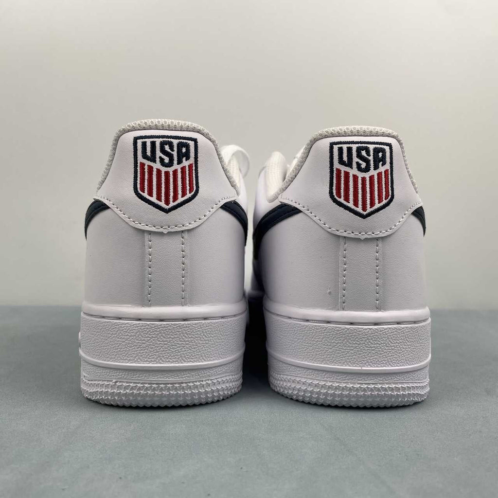 AF1-040 USA Soccer Tribute – pair on box three-quarter view showing white leather upper, navy swoosh, and silver AF1 dubrae