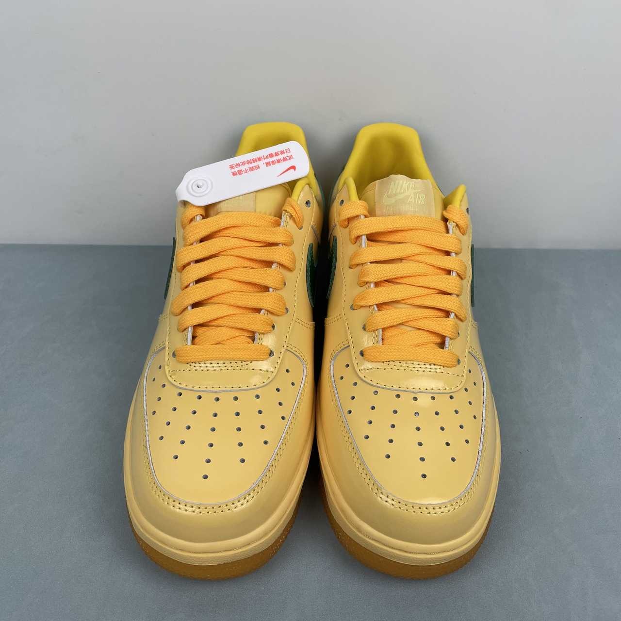 AF1-038 Vanilla Forest Patent – pair three-quarter view showing yellow laces, cream patent upper, and green swoosh
