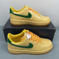 AF1-038 Vanilla Forest Patent – front toe box view showing cream patent upper, yellow laces, and green swoosh tips